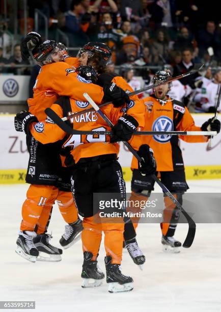 Brent Aubin of Wolfsburg celebrate with his team mates after he scores the 4th goal during the DEL Playoffs quarter finals Game 4 between Grizzlya...