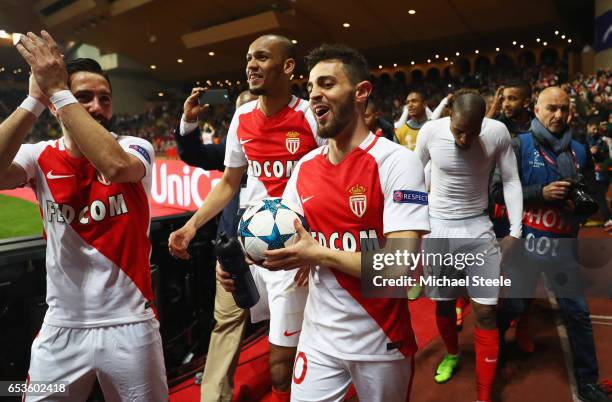 Bernardo Silva of AS Monaco celebrates victory with team mates Joao Moutinho and Fabinho after the UEFA Champions League Round of 16 second leg match...