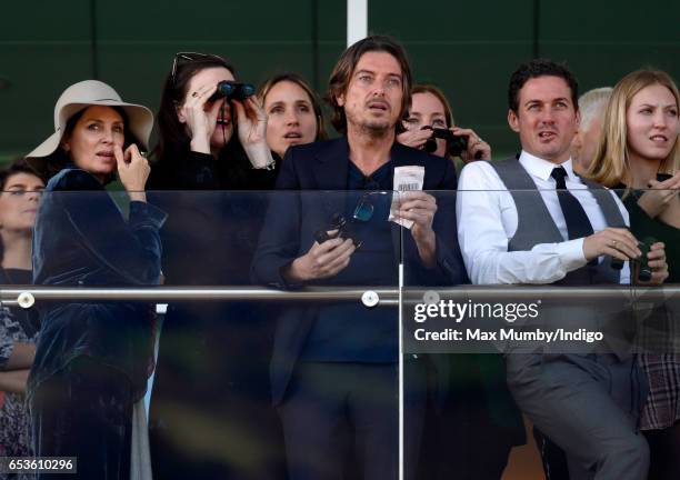 Sadie Frost, Liv Tyler, Darren Strowger and Dave Gardner watch the racing as they attend day 2 'Ladies Day' of the Cheltenham Festival at Cheltenham...