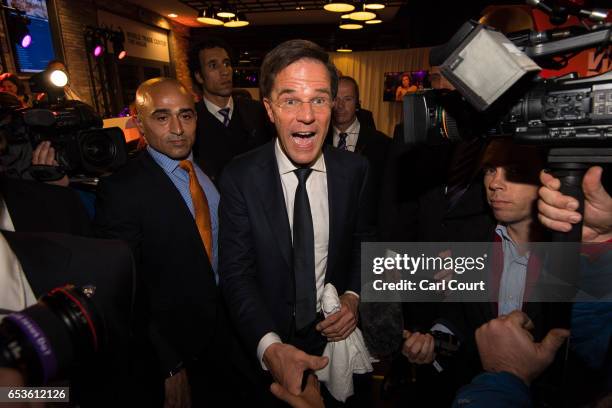 Dutch Prime Minister Mark Rutte is greeted by supporters as he leaves after making a speech following his victory in the Dutch general election on...