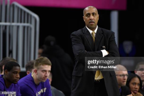 Head coach Lorenzo Romar of the Washington Huskies looks on during a first-round game of the Pac-12 Basketball Tournament against the USC Trojans at...