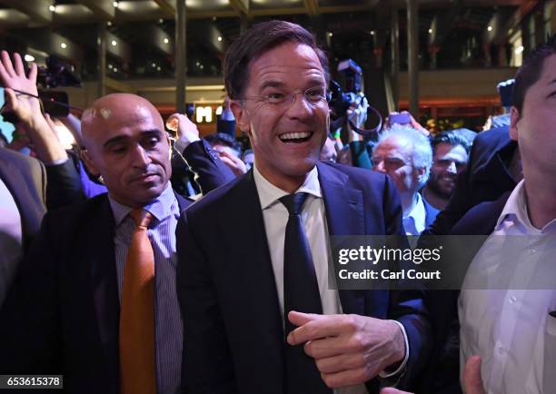 Dutch Prime Minister Mark Rutte is greeted by supporters as he arrives to make a speech following his victory in the Dutch general election on March...