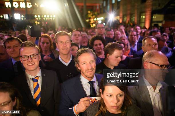 Supporters look on as Dutch Prime Minister Mark Rutte makes a speech following his victory in the Dutch general election on March 15, 2017 in The...