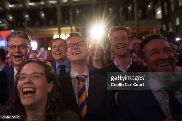 Supporters look on as Dutch Prime Minister Mark Rutte makes a speech following his victory in the Dutch general election on March 15, 2017 in The...
