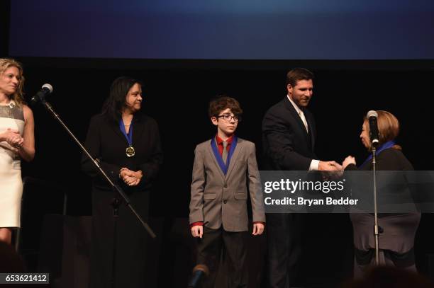 Hillary Schafer and Chris Stakich present medallions to LEAD360 Activation Winners onstage during the Jefferson Awards Foundation 2017 NYC National...