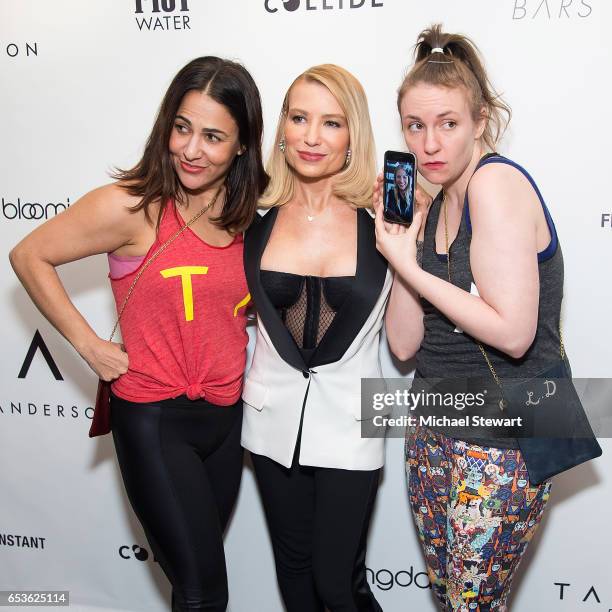 Jennifer Konner and Tracy Anderson pose with Lena Dunham while she video chats with Gwyneth Paltrow during the Tracy Anderson Flagship Studio opening...