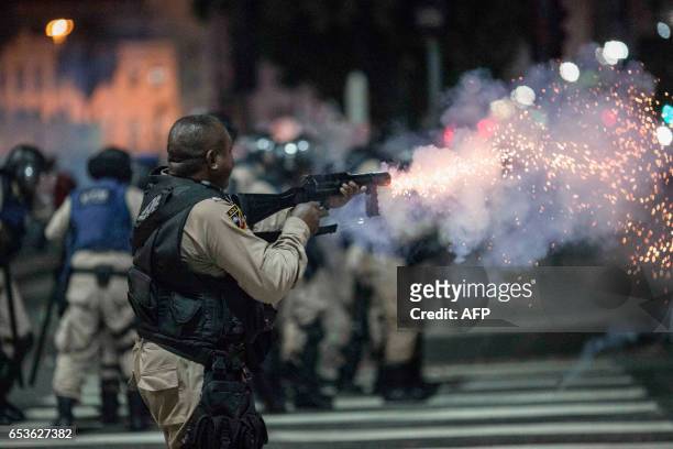 Municipal guard in riot gear fires rubber bullets at protesters during a national strike against the government's social welfare reform bill which...