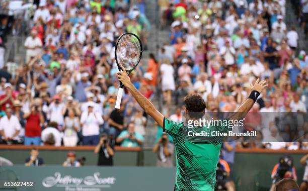 Roger Federer of Switzerland celebrates to the crowd after his straight sets victory against Rafael Nadal of Spain in their fourth round match during...