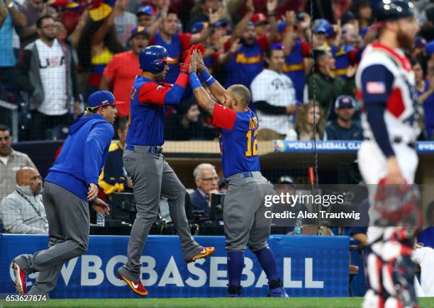 Carlos Gonzalez of Team Venezuela celebrates with teammate Rougned Odor after scoring in the third inning of Game 2 of Pool F of the 2017 World...