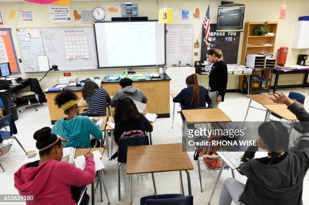 Science teacher Virginia Escobar-Cheng works with her students in a science class in a high school in Homestead, Florida, on March 10, 2017. Texas...