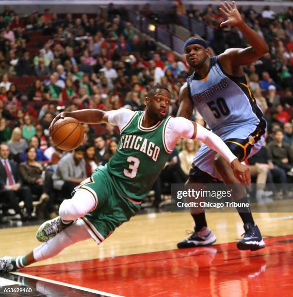 The Chicago Bulls' Dwyane Wade slips while going around the Memphis Grizzlies' Zach Randolph during the first half at the United Center in Chicago on...