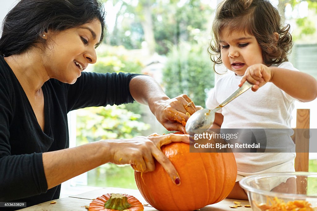 Mother and Baby Daughter Carving a Pumpkin