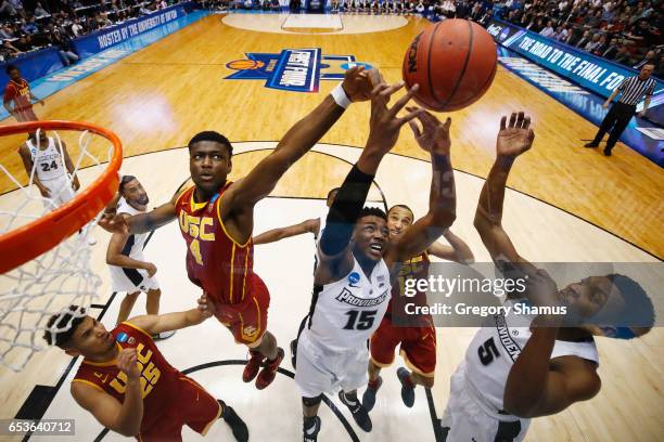 Chimezie Metu of the USC Trojans battles for a rebound with Emmitt Holt and Rodney Bullock of the Providence Friars in the second half during the...