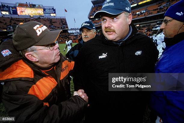 Head Coach Andy Reid of the Philadelphia Eagles shakes hands with Head Caoch Chris Palmer of the Cleveland Browns at the Cleveland Stadium in...