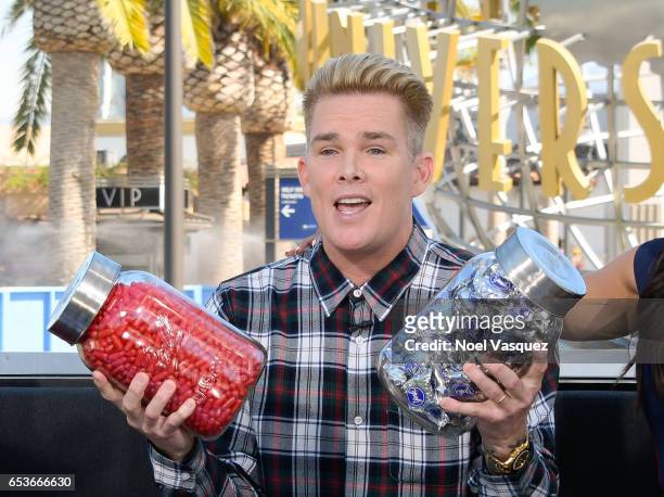 Mark McGrath holds his birthday presents at "Extra" at Universal Studios Hollywood on March 15, 2017 in Universal City, California.