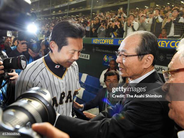 Manager Hiroki Kokubo of Japan is congratulated by former manager Sadaharu Oh after the World Baseball Classic Pool E Game Six between Israel and...