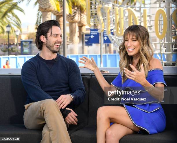 Milo Ventimiglia and Renee Bargh visit "Extra" at Universal Studios Hollywood on March 15, 2017 in Universal City, California.