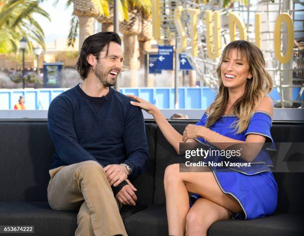 Milo Ventimiglia and Renee Bargh visit "Extra" at Universal Studios Hollywood on March 15, 2017 in Universal City, California.