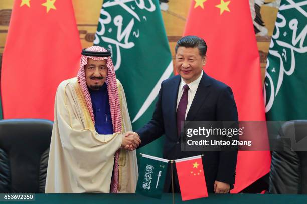Chinese President Xi Jinping shake hands with Saudi Arabia's King Salman bin Abdulaziz Al Saud during a signing ceremony at the Great Hall of the...
