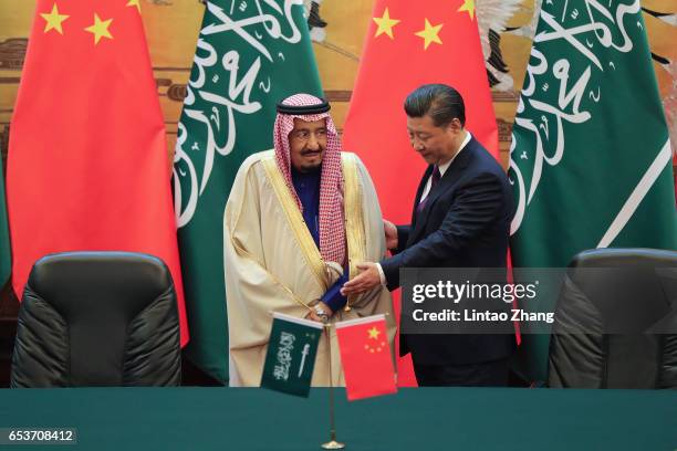 Chinese President Xi Jinping shake hands with Saudi Arabia's King Salman bin Abdulaziz Al Saud during a signing ceremony at the Great Hall of the...