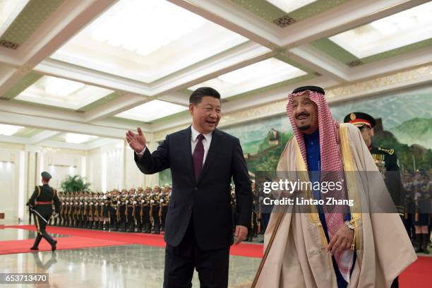 Chinese President Xi Jinping accompanies Saudi Arabia's King Salman bin Abdulaziz Al Saud to view an honour guard during a welcoming ceremony inside...