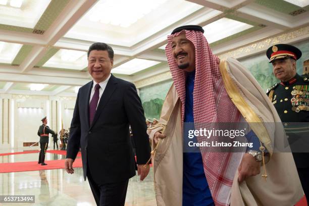 Chinese President Xi Jinping accompanies Saudi Arabia's King Salman bin Abdulaziz Al Saud to view an honour guard during a welcoming ceremony inside...