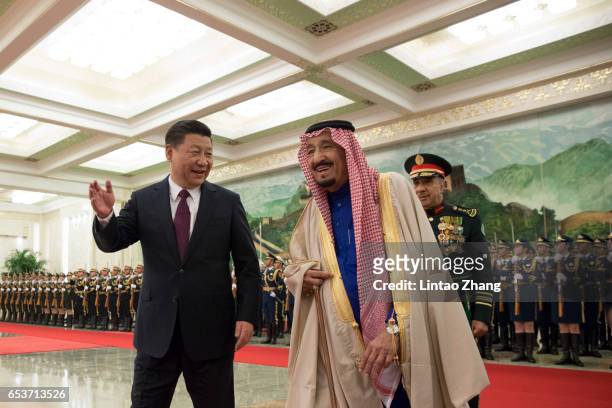 Chinese President Xi Jinping accompanies Saudi Arabia's King Salman bin Abdulaziz Al Saud to view an honour guard during a welcoming ceremony inside...