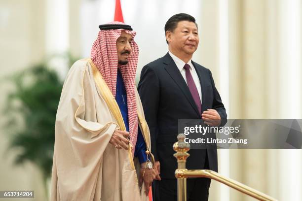 Chinese President Xi Jinping and Saudi Arabia's King Salman bin Abdulaziz Al Saud listen to their national anthems during a welcoming ceremony inside...