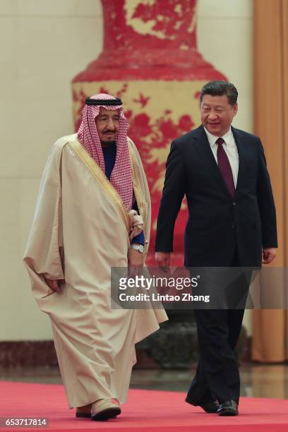 Chinese President Xi Jinping invites Saudi Arabia's King Salman bin Abdulaziz Al Saud to view an honour guard during a welcoming ceremony inside the...