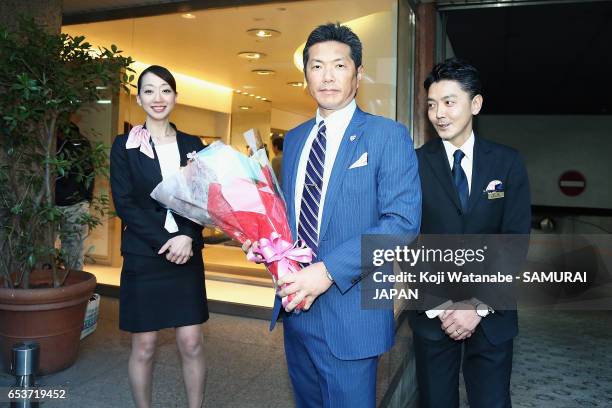 Manager Hiroki Kokubo of Japan poses for photographs as he leaves a hotel for the United States for the World Baseball Classic Championship Round on...