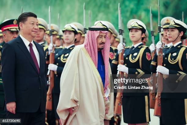 Chinese President Xi Jinping accompanies Saudi Arabia's king Salman bin Abdulaziz Al Saud listen to their national anthems during a welcoming...