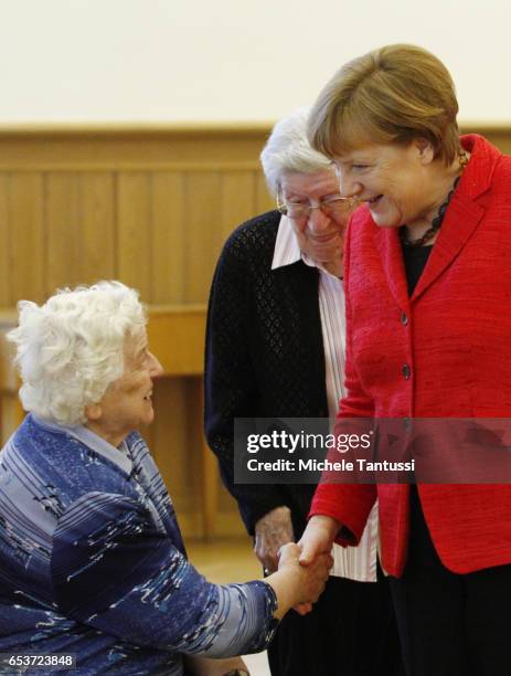 German Chancellor Angela Merkel speaks with senior citizens in the dance hall at the Paul-Gerhadt-Stift center on March 16, 2017 in Berlin, Germany....