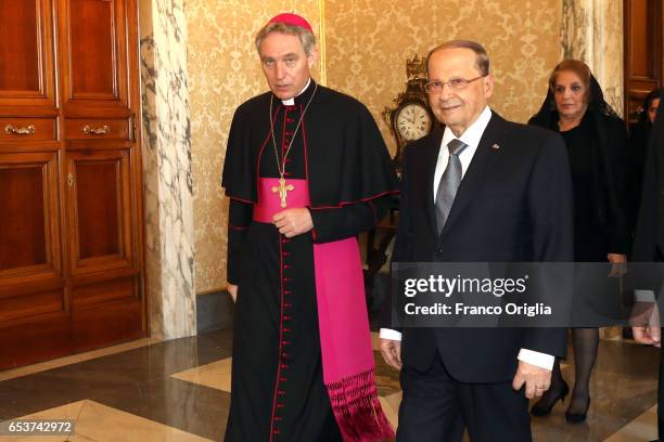 President of Lebanon Michel Aoun, flanked by the Prefect of the Pontifical House Georg Ganswein as they arrive at the Apostolic Palace to attend a...