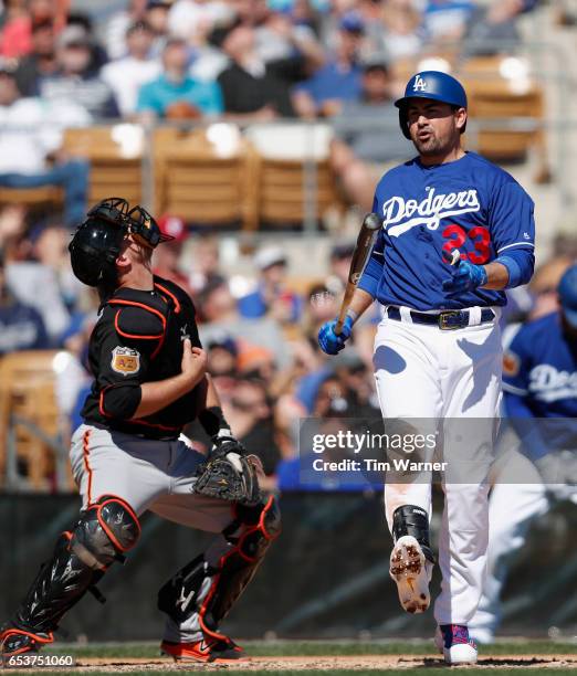 Adrian Gonzalez of the Los Angeles Dodgers reacts to hitting a foul ball against the San Francisco Giants during a spring training game at Camelback...