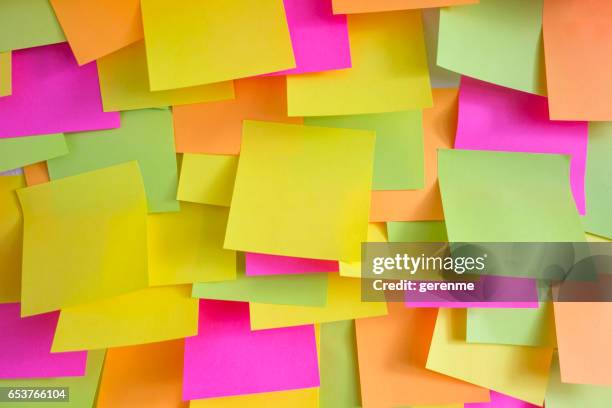 wall covered with adhesive notes - wall of sticky notes stock pictures, royalty-free photos & images