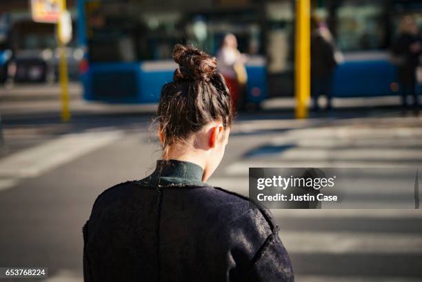 woman crossing street in the city - hair bun back stock pictures, royalty-free photos & images