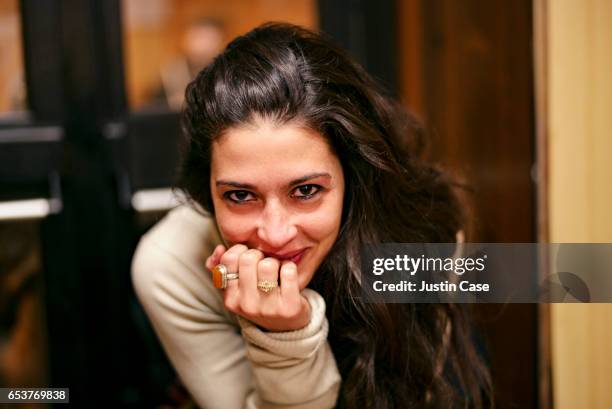 woman in a bar looking happily into camera - life ring stockfoto's en -beelden