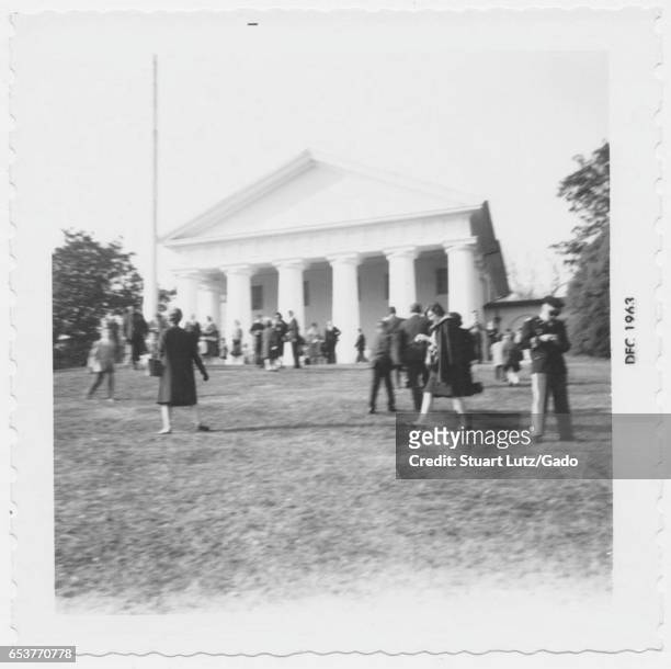 People gather at the grave of assassinated United States President John F Kennedy shortly after his death, at Arlington National Cemetery, Arlington,...