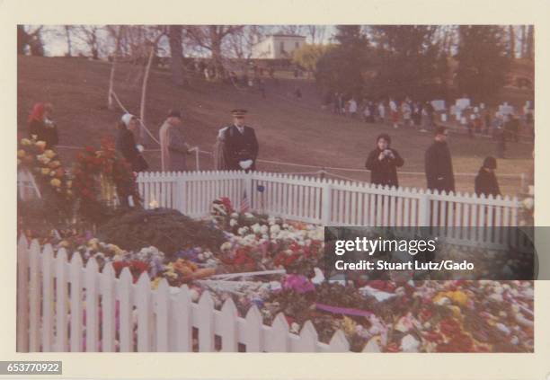 People gather at the grave of assassinated United States President John F Kennedy shortly after his death, at Arlington National Cemetery, Arlington,...