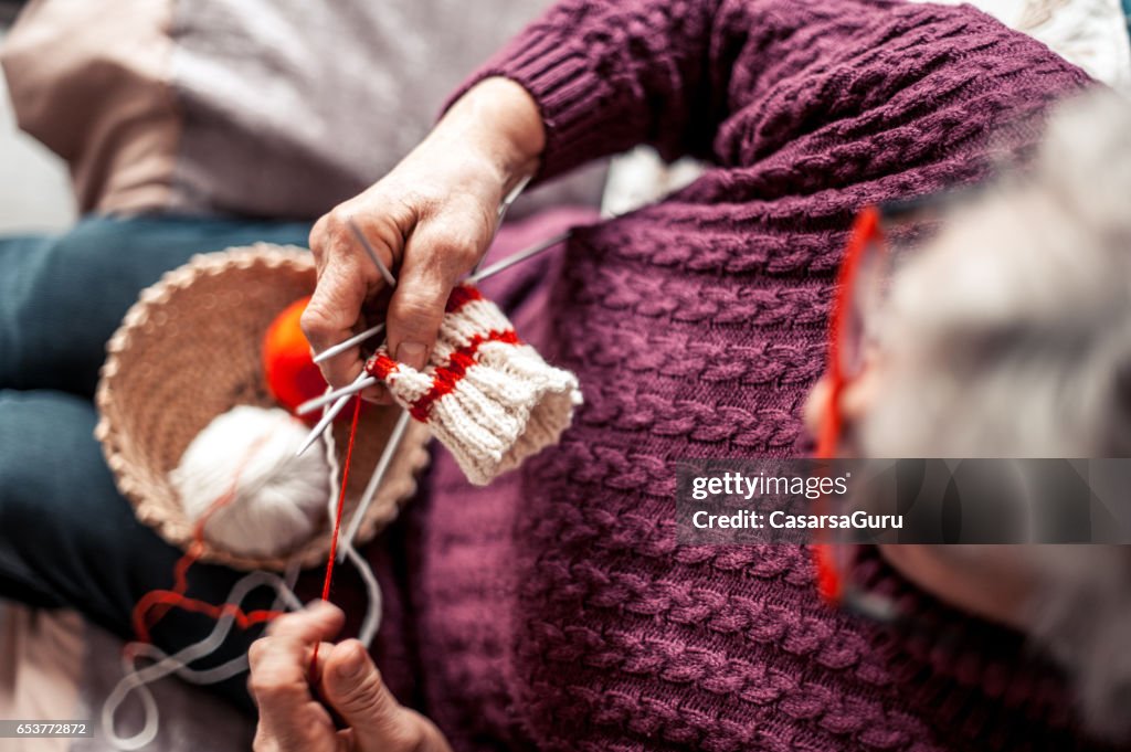 Senior Woman With Arthritic Hands Doing Crochet