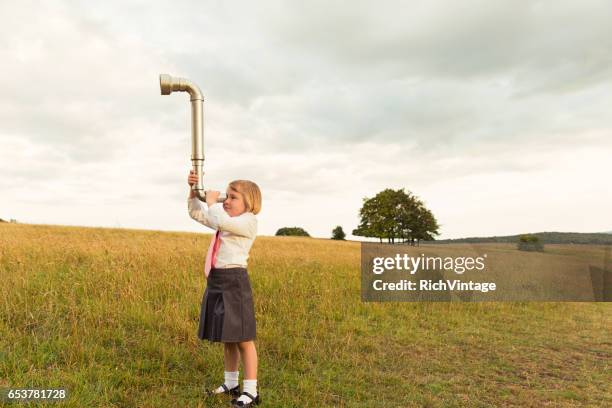 young girl businesswoman looks for business with periscope - periscope stock pictures, royalty-free photos & images