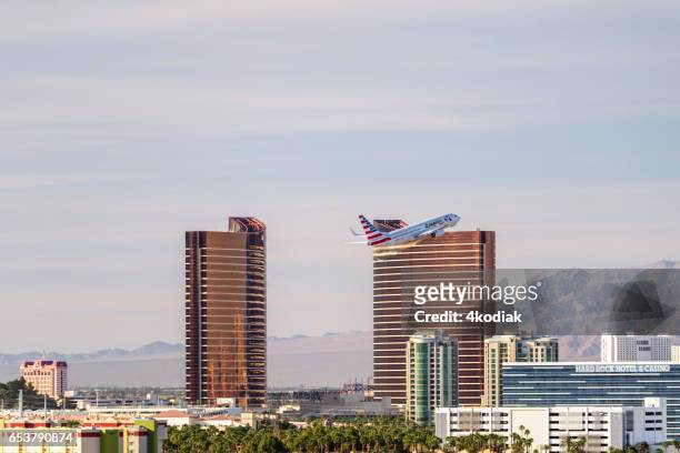 las vegas hotel casino buildings with airplane taking off. - wynn las vegas stock pictures, royalty-free photos & images