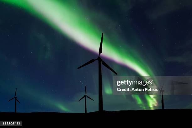 wind turbines on the background of the northern lights - wind turbine long exposure stock-fotos und bilder