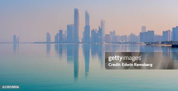 view of abu dhabi at sunrise - abu dhabi sunrise stock pictures, royalty-free photos & images