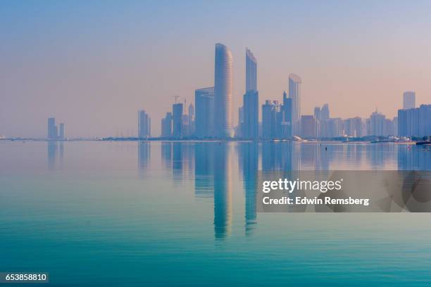 abu dhabi skyline - persian gulf stock pictures, royalty-free photos & images