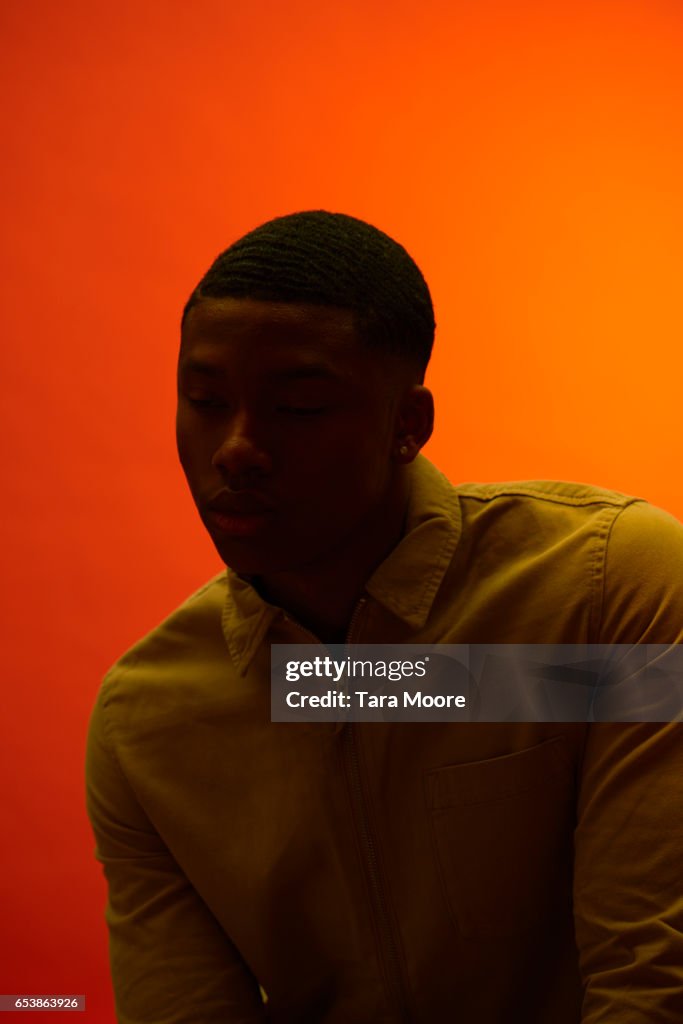 Man in shadow with orange background