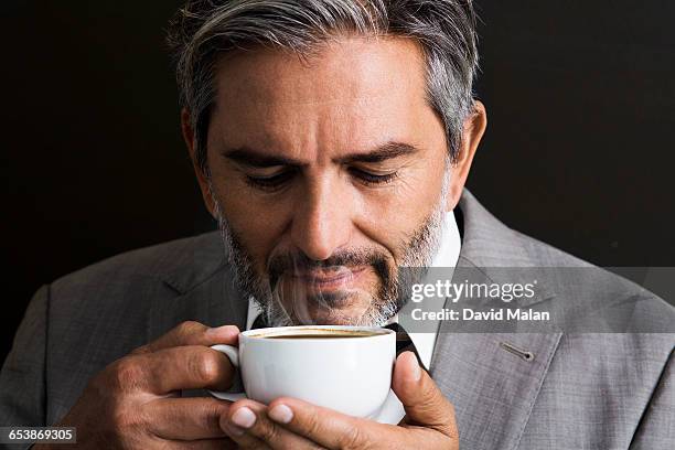 bearded businessman smelling coffee - david swallow stock pictures, royalty-free photos & images