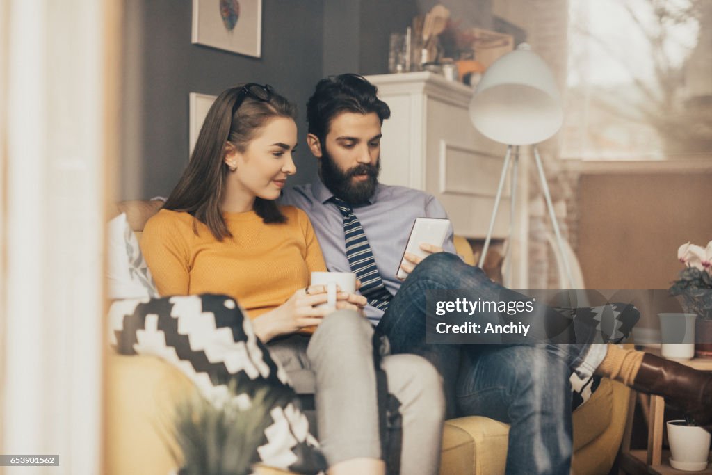 Couple is having a morning coffee together before leaving for work