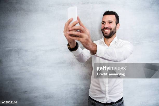selfie time - mid adult men stock pictures, royalty-free photos & images