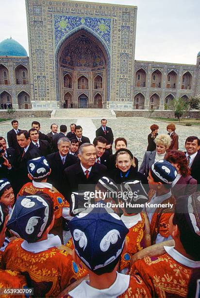 First Lady Hillary Clinton with Uzbek President Islam Karimov and his wife, Tatiana Karimova , chat with a group of young traditional Uzbek...